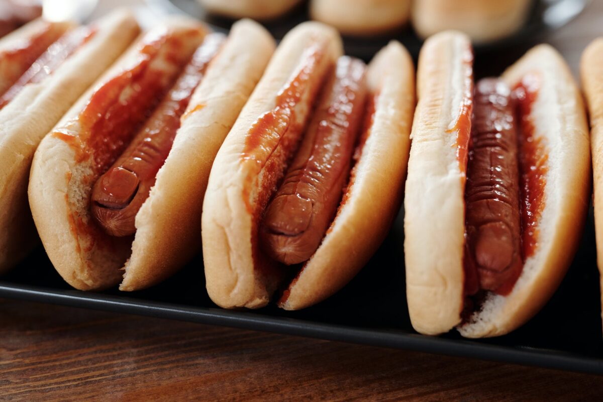 hotdog sandwiches on black tray